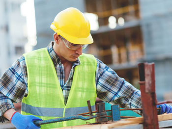 Contractor wearing construction gear while working on an industrial project